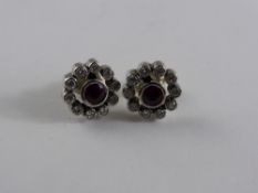 A Pair of Lady`s 18 ct White Gold Ruby and Diamond Stud Earrings, each ruby 3.5 mm surrounded by 10