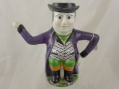 An Antique Staffordshire Style Tea Pot, depicting a Dickensian figure, approx 21 cms.