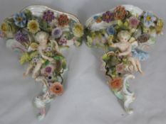 A Pair of Late 19th Century Sitzendorf Wall Brackets, floral encrusted, depicting a cherub seated.
