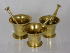 A Set of Three Antique Brass Graduated Pestle and Mortars.