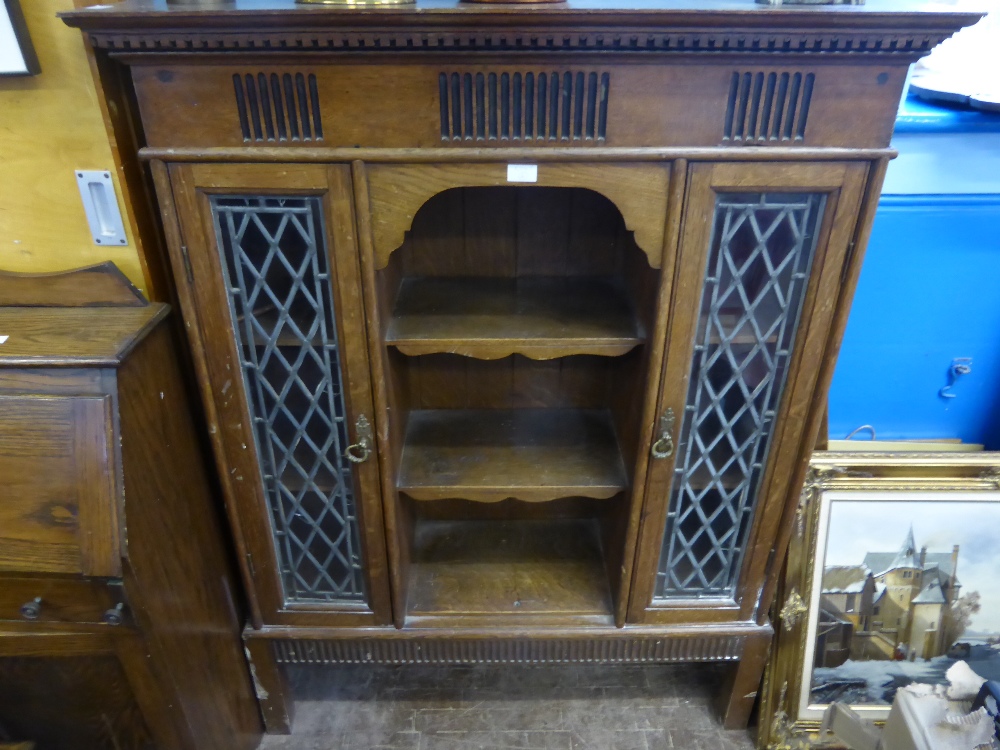 An Oak Edwardian Display Cabinet, with central shelving and two doors to either side with leaded