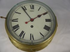 A Brass Ships Bridge Clock, enamel face with Roman dial, made in Great Britain.