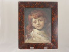 A Hand Painted Portrait on Panel, the portrait depicting an auburn haired young girl, monogram to