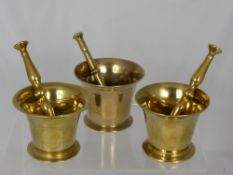 A Set of Three Antique Brass Graduated Pestle and Mortars.