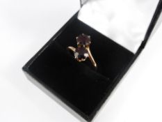 A Lady`s 9ct Gold Garnet Crossover Ring, together with a gold emerald and rose cut diamond ring. (