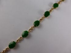 A Lady`s 14 ct (tested) Yellow Gold and Green Jade Bracelet, the bracelet set with 8 bright green