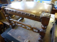 A brown leather topped oak foot stool on part turned legs and decorated stretchers, est, 56 x 36 x