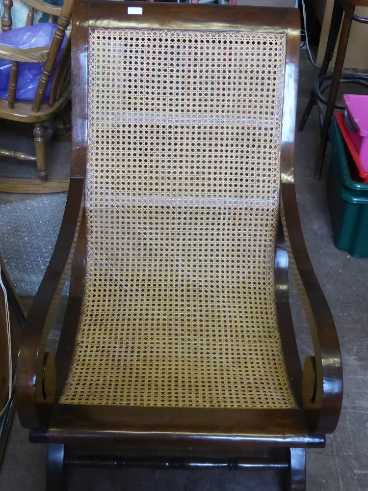 An antique rosewood bergere colonial style armchair, est. 63 x 103 x 92 cms.