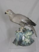 Porcelain Figure of a Bird of Prey, seated on a rock, marks to base, approx 36 cms