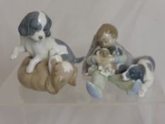 Lladro Porcelain Figurine Boy and Puppies, nr 1535, together with a figure of wrestling puppies. (