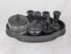 A Gentleman`s Ebony Dressing Table Set, comprising of ring stand, jars and candlesticks.