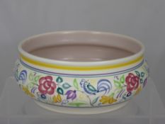 A Hand Painted Poole Pottery Bowl, the bowl decorated with birds and flowers, 23 cms dia, impressed