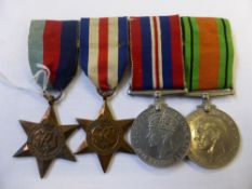 A group of four Second World War medals comprising War, Defence, France / Germany Star and 1945