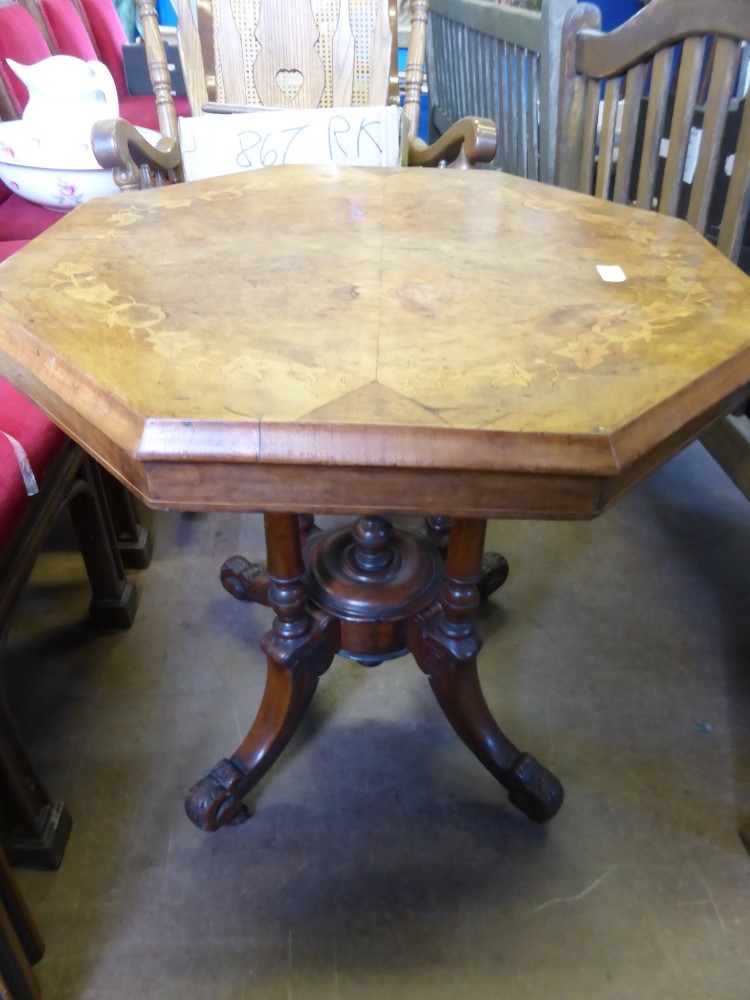 A Victorian octagonal walnut occasional table having inlaid floral decoration to the top on four