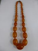 A Set of Butterscotch Oval Graduated Amber Beads, the centre bead 2.5 x 1.8 cms, approx 47 cms in