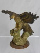 A Capo di Monte Golden Eagle figurine on an oak base approx 20 cms high.