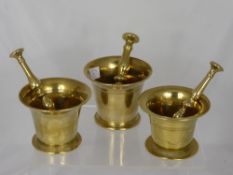 A Set of Three Antique Brass Graduated Pestle and Mortars.