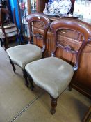 Four Mid Victorian Mahogany Balloon Back Dining Chairs with turned legs and velvet seats.