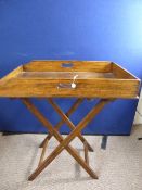 An oak butler`s table on a folding base, approx. 70 x 45 x 85 cms.