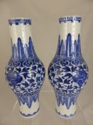 A pair of Chinese Blue and White Bottle Vases with central floral band and acanthus leaf decoration