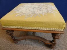 Antique oak foot stool, the top being covered in a gold coloured material depicting flowers, the