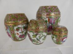 Set of four graduated antique Chinese famille rose gilded lidded pots depicting various scenes of