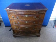 Bow front mahogany veneered chest of drawers having a brush slide and four graduated drawers on