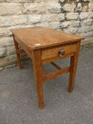 Vintage pine kitchen table on turned legs united by two stretchers and being fitted with a drawer