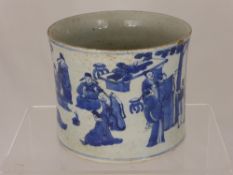 A 20th Century Blue and White Brush Pot, depicting figures relaxing in a garden, approx 22 cms.