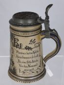 Vintage German pottery stein depicting lovers with German script to each side, the lid set with a