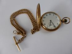 A gentleman`s 9ct gold full hunter pocket watch, Chester hallmarked and having a white enamel face,