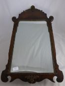 A Flame Mahogany Wall Mirror, label to the reverse, Atsonea, 78 x 42 cms.