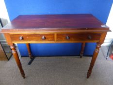 Victorian mahogany writing table on turned legs with two drawers, approx. 104 x 50 x 83 cms.