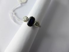 Lady`s 18 ct White Gold Sapphire and Diamond Three Stone Ring, 2 x 50 pts diamonds, centre sapphire