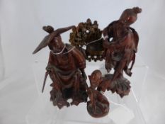 Three Chinese Decorative Wood Carvings, a fisherman, an elder, a kneeling figure together with a