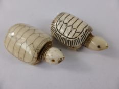 Two carved bone figures of turtles together with a netsuke tiger (3)