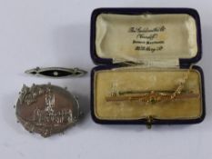 Collection of three miscellaneous brooches, including 9ct gold pin brooch set with green stone