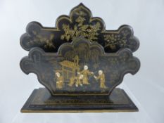 Five oriental lacquer items comprising a letter holder, a card tray, two caddy lids and a trinket