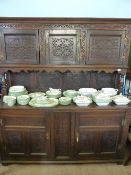 Victorian ornately carved oak dresser having a canopied top with three cupboards, the base having