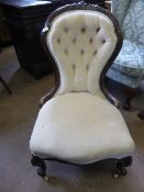 Victorian spoon back bedroom chair having button back on ball feet and castors, upholstered in