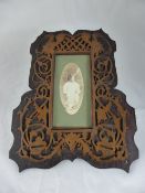 Two fretwork picture frames depicting mythical birds.