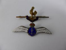 A silver and enamel Fleet Air Arm sweetheart badge together with a gold metal and enamel H M S