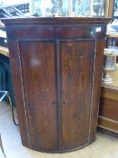 Victorian bow fronted mahogany corner cupboard, two doors enclosing two shelves, approx. 68 x 43 x