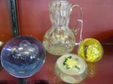 Collection of Glass including a hand blown water decanter and three glass paperweights.