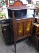 Edwardian mahogany cabinet having an open shelf below the top with cupboard under, the door having