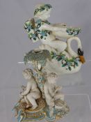 Continental decorative porcelain figure of a boy astride a swan, the figure having raised blue