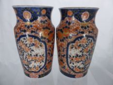 Antique Imari Vases, the barrel shaped vases having hand painted flowers with gilt highlights on a