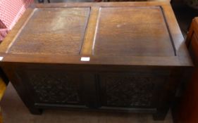 A Victorian oak blanket box having a panelled lid and decorative panels to the front, approx. 94 x