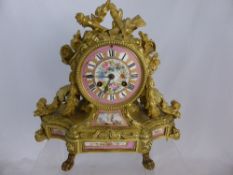 A 19th century French Ormulu Mantel Clock, Circular case surmounted with applied tied ribbon,