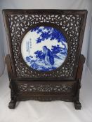 Chinese Blue and White Porcelain Panel, depicting fisherman, supported in a ornately carved screen